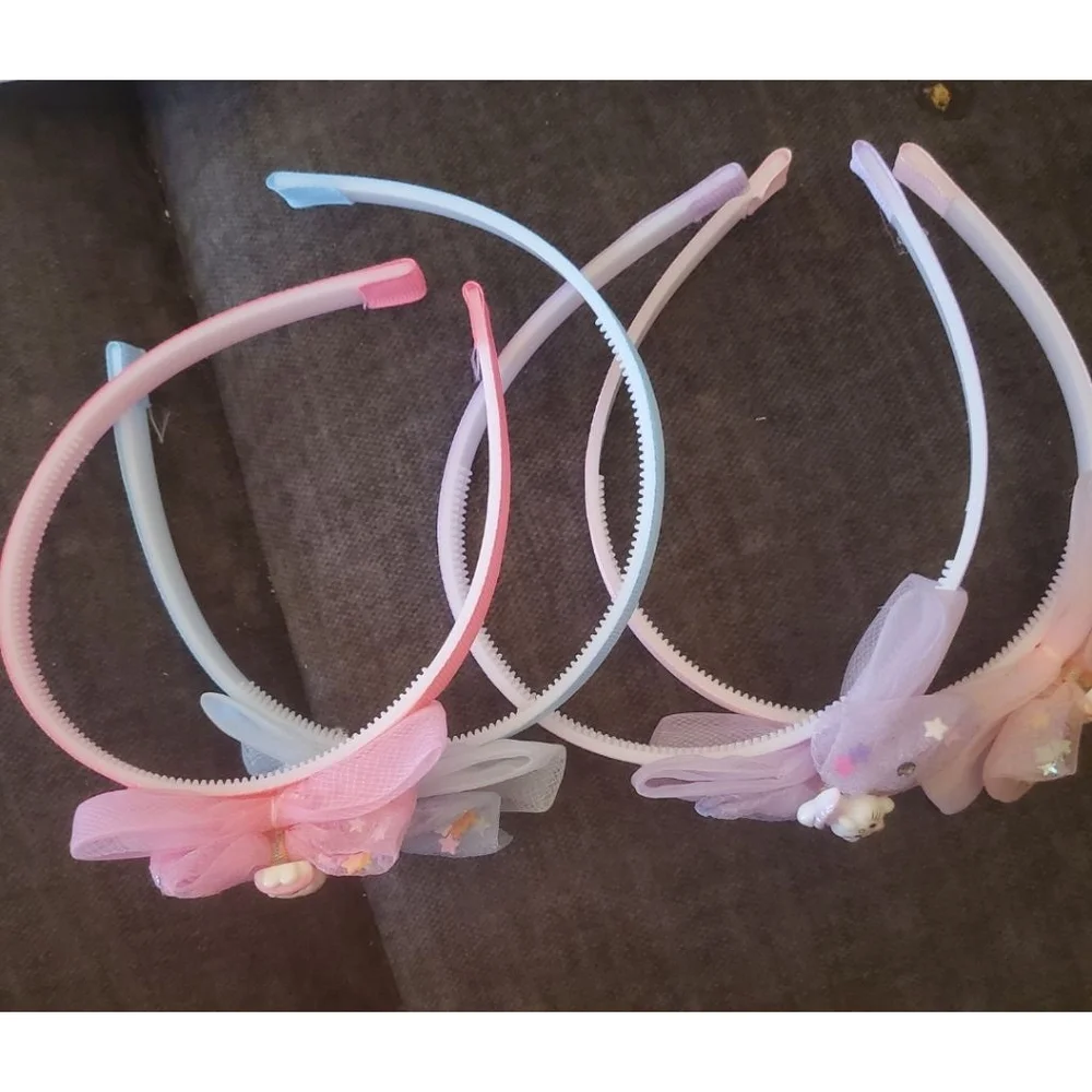Four Hello Kitty headbands with small figurine